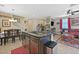 Open-concept kitchen featuring an island with granite countertops that flows into the living area at 9118 Mount Wilson St, Las Vegas, NV 89113