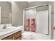 Bathroom with a shower over the tub, tile surround, and vanity at 93 Autumn Day St, Henderson, NV 89012
