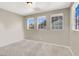 Bedroom featuring ample sunlight from three windows and neutral carpeting at 93 Autumn Day St, Henderson, NV 89012