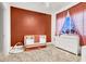 Inviting Bedroom with a crib, dresser, and window for ample natural light, creating a cozy atmosphere at 93 Autumn Day St, Henderson, NV 89012