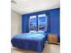 Cozy bedroom with a blue accent wall, natural light, and simple furnishings for a peaceful retreat at 93 Autumn Day St, Henderson, NV 89012