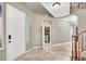 Bright foyer features tile flooring, staircase, and access to the laundry room at 93 Autumn Day St, Henderson, NV 89012