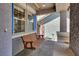 Cozy covered front porch with a wooden porch swing and decorative columns at 93 Autumn Day St, Henderson, NV 89012