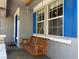Inviting front porch with a wooden swing seat at 93 Autumn Day St, Henderson, NV 89012