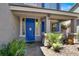 Inviting front porch with a bright blue door and well-manicured landscaping at 93 Autumn Day St, Henderson, NV 89012