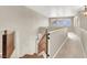 Hallway with wood railing, carpet, and multiple windows letting in natural light at 93 Autumn Day St, Henderson, NV 89012