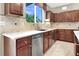 Well-appointed kitchen featuring stainless steel appliances, tile backsplash, and custom cabinetry at 93 Autumn Day St, Henderson, NV 89012