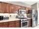 Well-equipped kitchen featuring stainless steel appliances and warm wood cabinetry at 93 Autumn Day St, Henderson, NV 89012