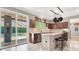 Modern kitchen featuring stainless steel appliances, center island, and sliding glass door leading to pool at 93 Autumn Day St, Henderson, NV 89012