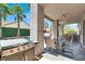 Outdoor kitchen with a built-in grill, ample counter space, and comfortable seating area at 93 Autumn Day St, Henderson, NV 89012