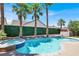 Inviting pool and spa area surrounded by lush palm trees, perfect for relaxation and entertainment at 93 Autumn Day St, Henderson, NV 89012