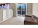 Inviting sitting room featuring a built-in bookshelf and sliding door to the patio at 93 Autumn Day St, Henderson, NV 89012