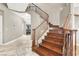 Elegant staircase featuring wood steps and railing, leading to the upper level at 93 Autumn Day St, Henderson, NV 89012