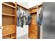 Organized walk-in closet with hanging clothes, drawers, and shelves, optimizing storage and accessibility at 93 Autumn Day St, Henderson, NV 89012
