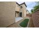This backyard shows neutral tones with gravel landscaping and a compact grass feature and sliding door at 9312 Poseidon Valley Ave, Las Vegas, NV 89178