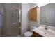 Bathroom with walk-in shower, vanity, and wooden medicine cabinet at 9312 Poseidon Valley Ave, Las Vegas, NV 89178
