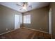 Cozy carpeted bedroom with a ceiling fan and a large window at 9312 Poseidon Valley Ave, Las Vegas, NV 89178