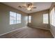 A bedroom with ample natural light from three windows and a ceiling fan at 9312 Poseidon Valley Ave, Las Vegas, NV 89178