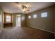Large carpeted bedroom with neutral walls, ceiling fan, and built-in desk at 9312 Poseidon Valley Ave, Las Vegas, NV 89178
