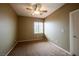 Carpeted bedroom with neutral walls, a ceiling fan, and natural light at 9312 Poseidon Valley Ave, Las Vegas, NV 89178