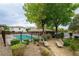 Community pool area with well manicured landscaping and lounge seating at 9312 Poseidon Valley Ave, Las Vegas, NV 89178