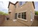 Exterior view of this two-story home featuring multiple windows and a sliding glass door at 9312 Poseidon Valley Ave, Las Vegas, NV 89178