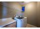 Laundry room featuring modern washer and dryer, storage cabinets, and shelving at 9312 Poseidon Valley Ave, Las Vegas, NV 89178