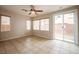 Spacious living room featuring tile flooring, neutral walls, bright windows, and backyard access at 9312 Poseidon Valley Ave, Las Vegas, NV 89178