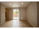 Bright living room featuring tile flooring, neutral walls, recessed lighting, and backyard access at 9312 Poseidon Valley Ave, Las Vegas, NV 89178