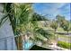 Balcony view framed by a palm tree overlooking a lush green lawn and blue swimming pool at 940 Vegas Valley Dr, Las Vegas, NV 89109