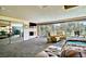 Bright main bedroom featuring a fireplace, sliding glass doors, and comfortable chairs overlooking the backyard at 940 Vegas Valley Dr, Las Vegas, NV 89109