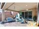 Covered back patio featuring an outdoor dining set and comfortable seating, great for entertaining at 9537 Wild Valley Ave, Las Vegas, NV 89148