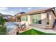 Backyard showcases a pool, covered patio, and ample seating, perfect for outdoor entertaining at 9537 Wild Valley Ave, Las Vegas, NV 89148