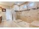 Accessible bathroom with large glass shower, shower seat, grab bar, and tile flooring at 9537 Wild Valley Ave, Las Vegas, NV 89148