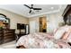 Comfortable bedroom features a ceiling fan, plush floral bedspread, and elegant furniture at 9537 Wild Valley Ave, Las Vegas, NV 89148