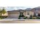 Charming single-story home featuring desert landscaping, a tile roof, and an attached two-car garage at 9537 Wild Valley Ave, Las Vegas, NV 89148