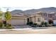 Attractive single-story home featuring desert landscaping, a tile roof, and an attached two-car garage at 9537 Wild Valley Ave, Las Vegas, NV 89148