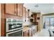 Kitchen with built-in stainless steel appliances, wooden cabinets, and tile backsplash at 9537 Wild Valley Ave, Las Vegas, NV 89148