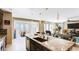 Open-concept kitchen with island, granite countertop, and views to dining and living areas at 9537 Wild Valley Ave, Las Vegas, NV 89148