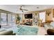 Spacious living room featuring large sliding glass doors, neutral paint, and modern furnishings at 9537 Wild Valley Ave, Las Vegas, NV 89148