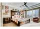 Bright main bedroom featuring decorative headboard, tray ceiling, ceiling fan, and natural light at 9537 Wild Valley Ave, Las Vegas, NV 89148