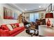 Cozy office space with a bright red sofa and built-in bookshelves at 9537 Wild Valley Ave, Las Vegas, NV 89148
