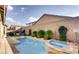Backyard pool and spa are accented with manicured desert plants and a privacy wall at 9537 Wild Valley Ave, Las Vegas, NV 89148