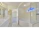 Modern bathroom featuring a soaking tub, glass enclosed shower and arched window at 9746 Driftwood Island Ct, Las Vegas, NV 89148