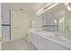 Spacious bathroom featuring double vanity, marble shower, and neutral tile floors at 9746 Driftwood Island Ct, Las Vegas, NV 89148