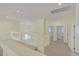 Open second floor hallway with glass railing and multiple rooms at 9746 Driftwood Island Ct, Las Vegas, NV 89148