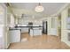 Well-lit kitchen with island, stainless steel appliances, white cabinetry and backyard access at 9746 Driftwood Island Ct, Las Vegas, NV 89148