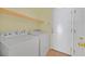 Bright laundry room featuring a Whirlpool washer and dryer and access door at 9746 Driftwood Island Ct, Las Vegas, NV 89148