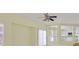 Bright living room with ceiling fan, large windows and view to the kitchen at 9746 Driftwood Island Ct, Las Vegas, NV 89148