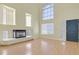 Bright living room features a fireplace, ample natural light, and hardwood floors at 9746 Driftwood Island Ct, Las Vegas, NV 89148